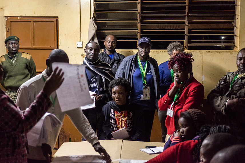 Once the polls closed, the ballots were counted by hand. Here, Carter Center co-leader and the former Prime Minister of Senegal Aminata Touré (center, in hat) watches as the ballots are counted.