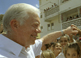 Former U.S. President Jimmy Carter shakes the hands of eager schoolchildren during his historic trip to Cuba.