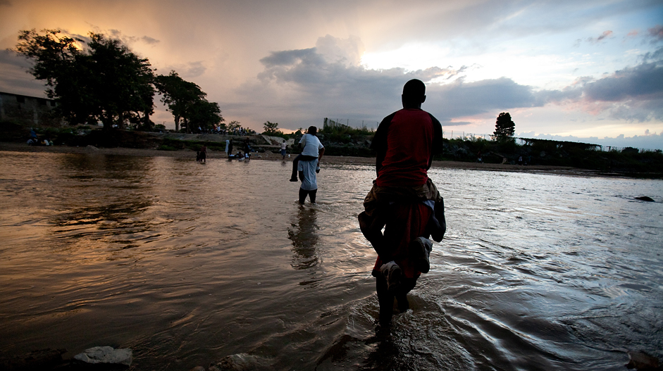 Haitians cross the Massacre River.