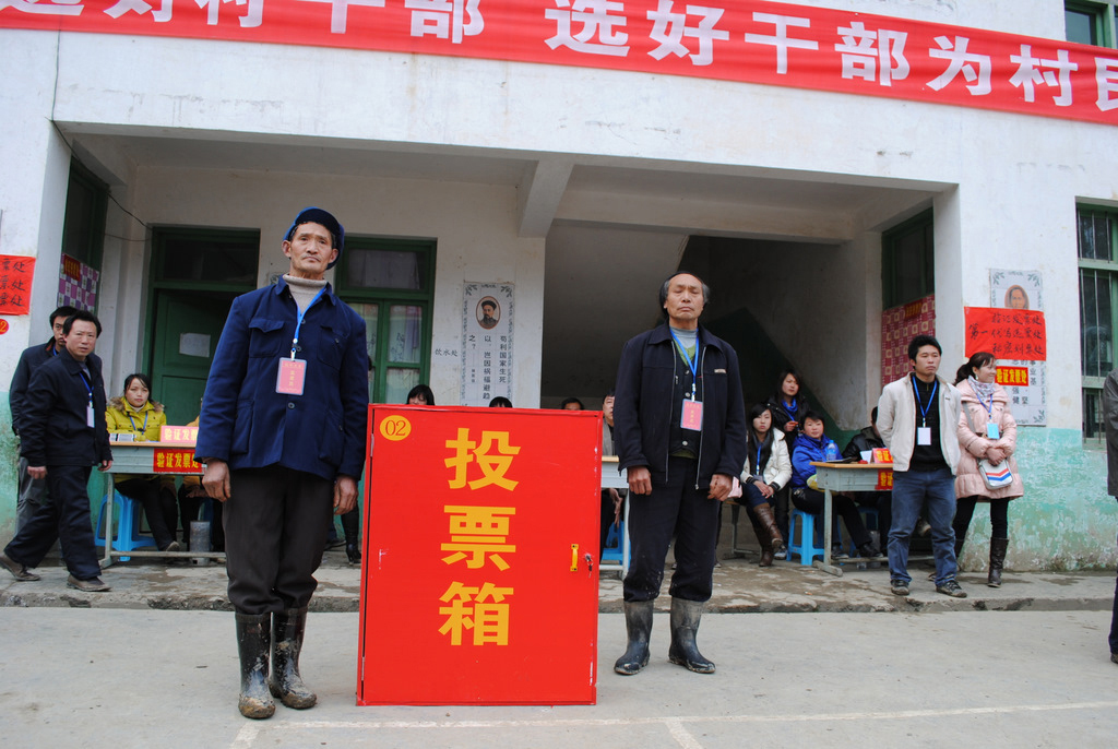 Officials guard the ballot box after voting on March 10.