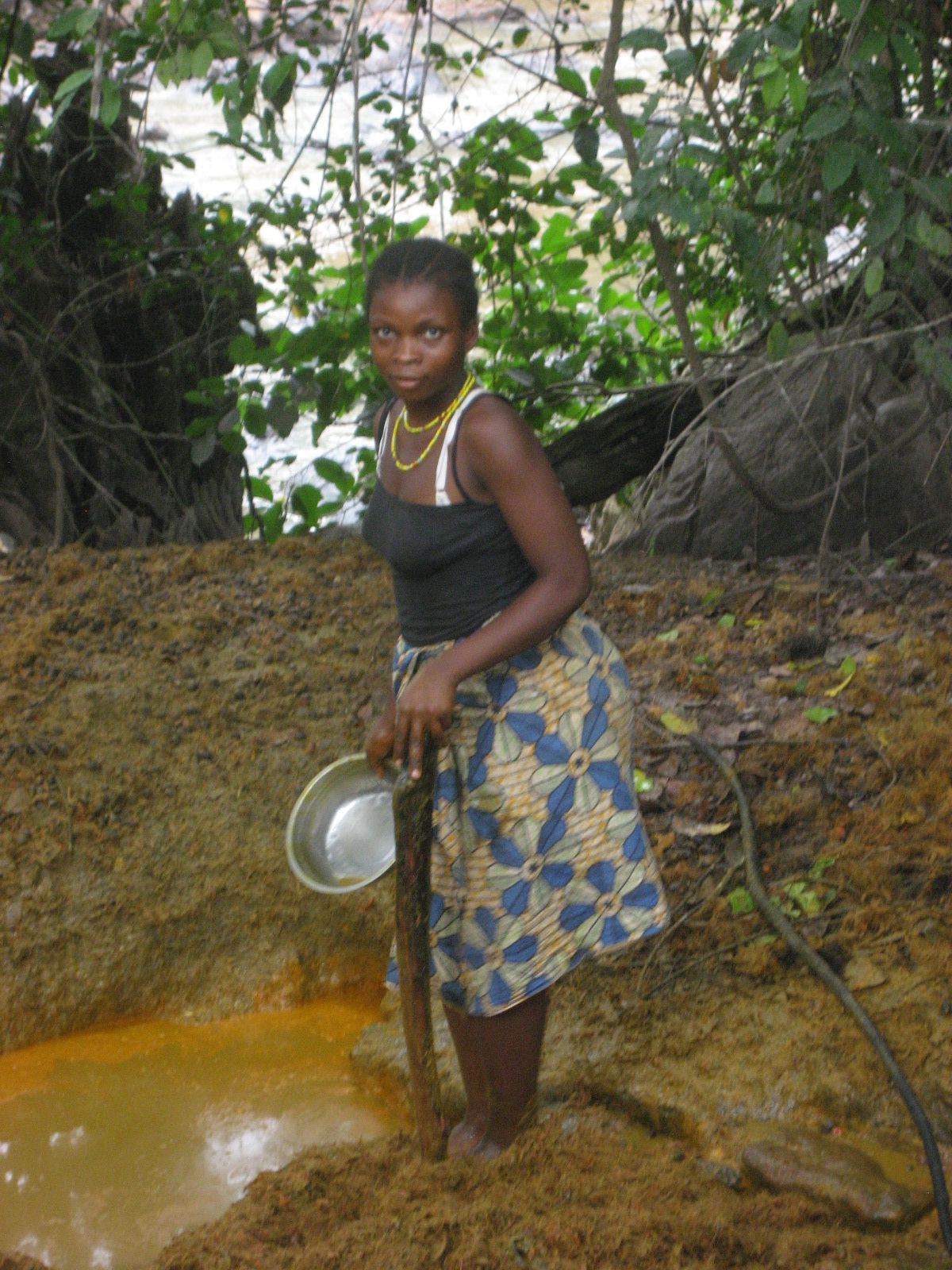 Woman making palm oil near river