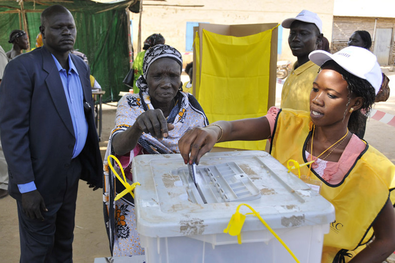 A polling official helps a woman cast her ballot on Jan. 9 in Juba.