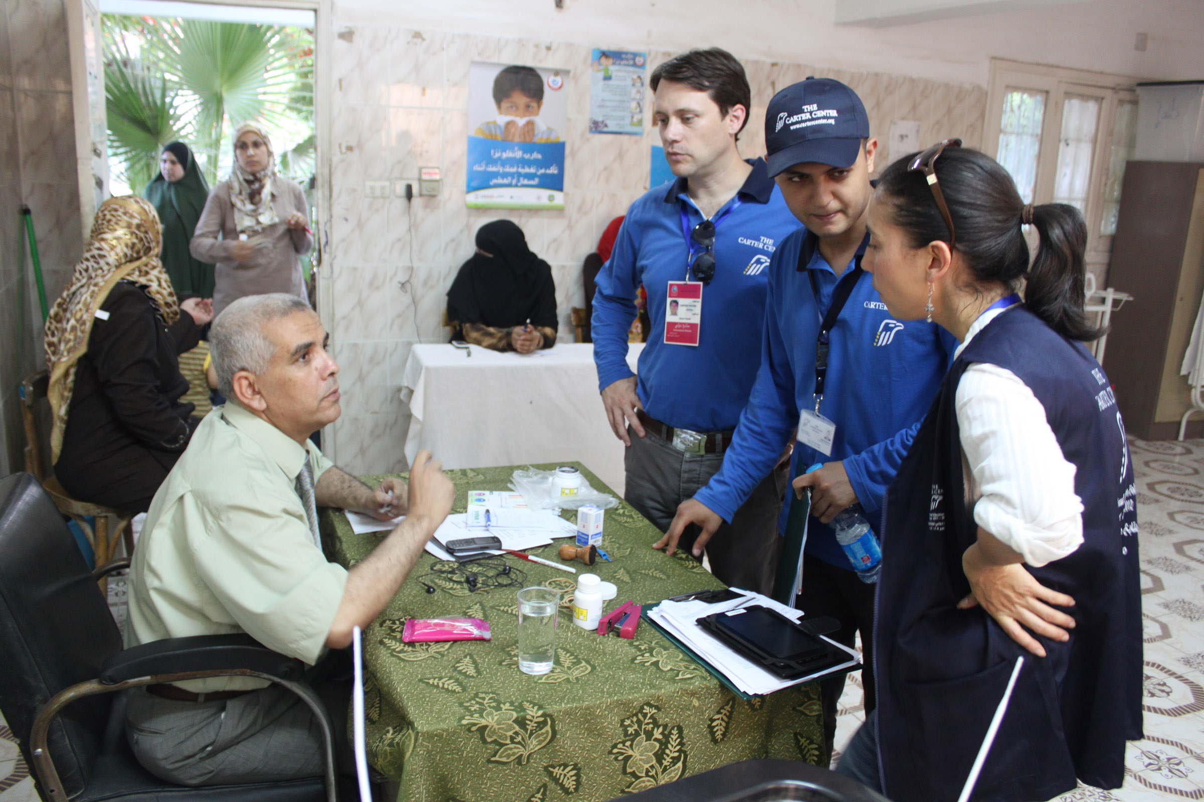 Carter Center Delegation Co-Leader and State Senator Jason Carter, Field Office Director Sanne van den Bergh, and logistics coordinator Sameh Ibrahim meet with a judge overseeing a polling station at Aisha Hasaneen Primary School in Fayoum. 