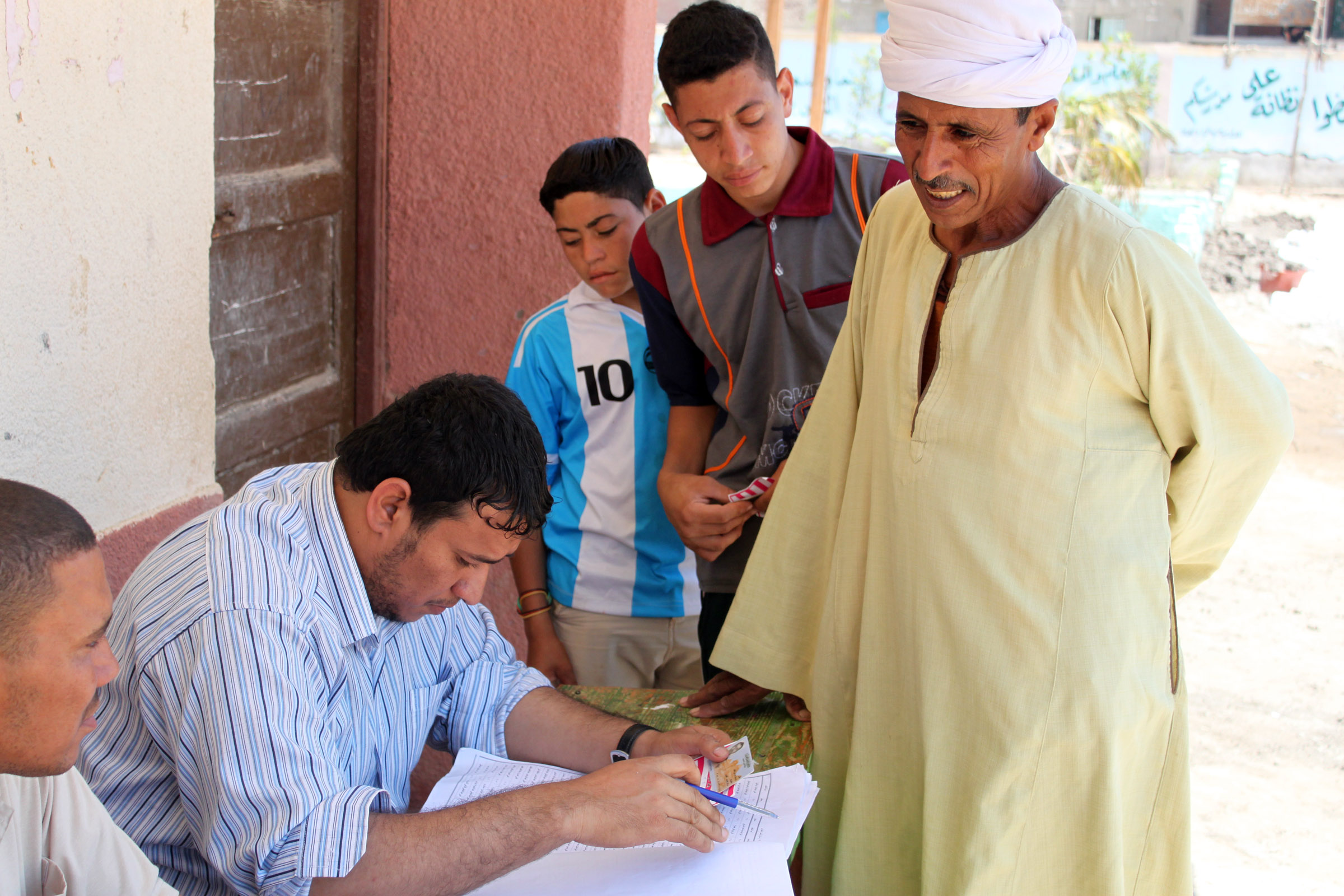 A man checks in to vote at the Shakshouk Preparatory School.