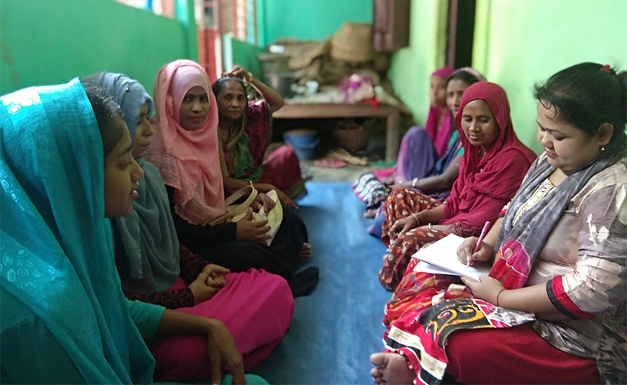 Photo of a group of women attending a courtyard meeting in Bangladesh village.