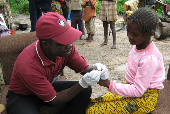 Solomon Izang tests Dorcas Azi for malaria.