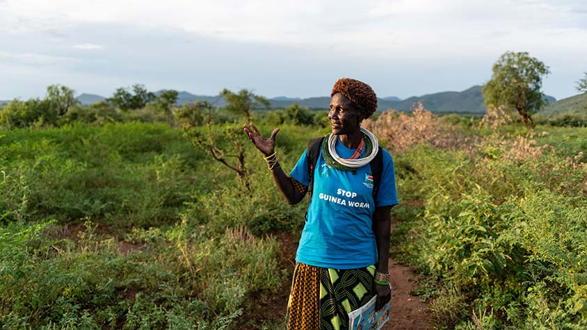 Photo of Regina Lotubai Lomare Lochilangole standing on a dirt road in South Sudan.