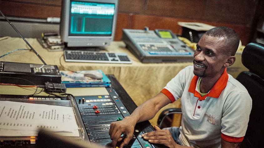 Photo of a Nigerien dj at a control board.