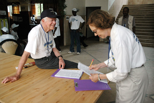 Former First Lady Rosalynn Carter organizes observation papers in preparation for poll closing procedures.