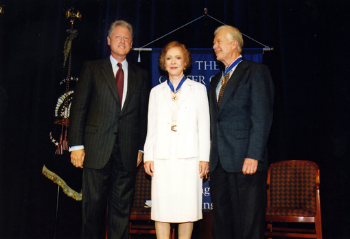 President and Mrs. Carter receive the Presidential Medal of Freedom from President Clinton at a ceremony at The Carter Center in Atlanta.