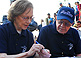 Photo of President and Mrs. Carter completing a polling center opening form while waiting for voting to begin in Bhaktapur, Nepal.