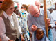 Former U.S. President Jimmy Carter and Carter Center CEO and President John Hardman measure a little girl's height to gauge the accurate medication needed to prevent schistosomiasis.