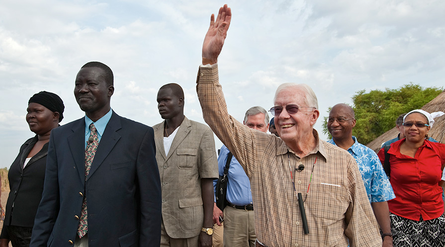 Jimmy Carter waves to a crown in southern Sudan.