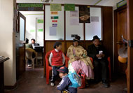 A family waits outside Rita Jimenez Huancollo's office at the Integrated Justice Center in La Paz, Bolivia.
