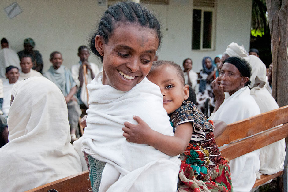 A mother and daughter wait with neighbors to receive medicine at a health clinic in North Gondar, Ethiopia. 