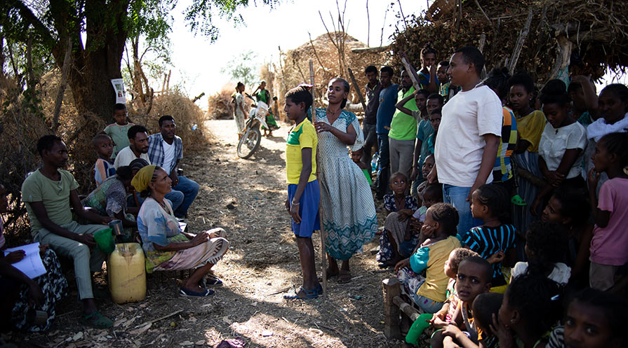 CDD Meleshew Sisay measures the height of one of her neighbors in Gondar District’s Mender 3 community to determine how many ivermectin tablets he should receive to prevent river blindness. The maximum dose, given to the tallest adults, is four tablets of Mectizan.