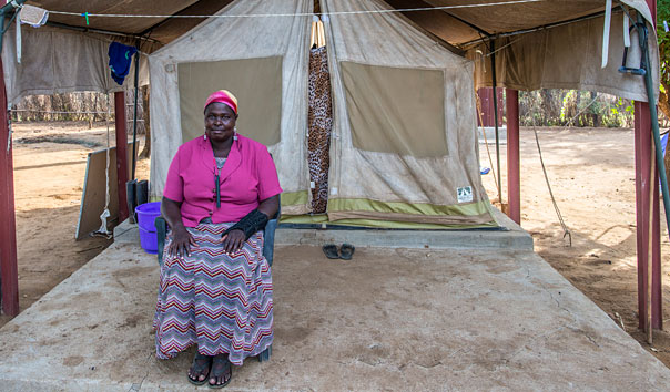 When Guinea worm disease is eradicated, Lomong'o says she will return home to Kenya to be closer to her mother and three daughters. Here she sits in front of her sleeping tent at a case containment center in Eastern Equitoria State, South Sudan, in 2013.